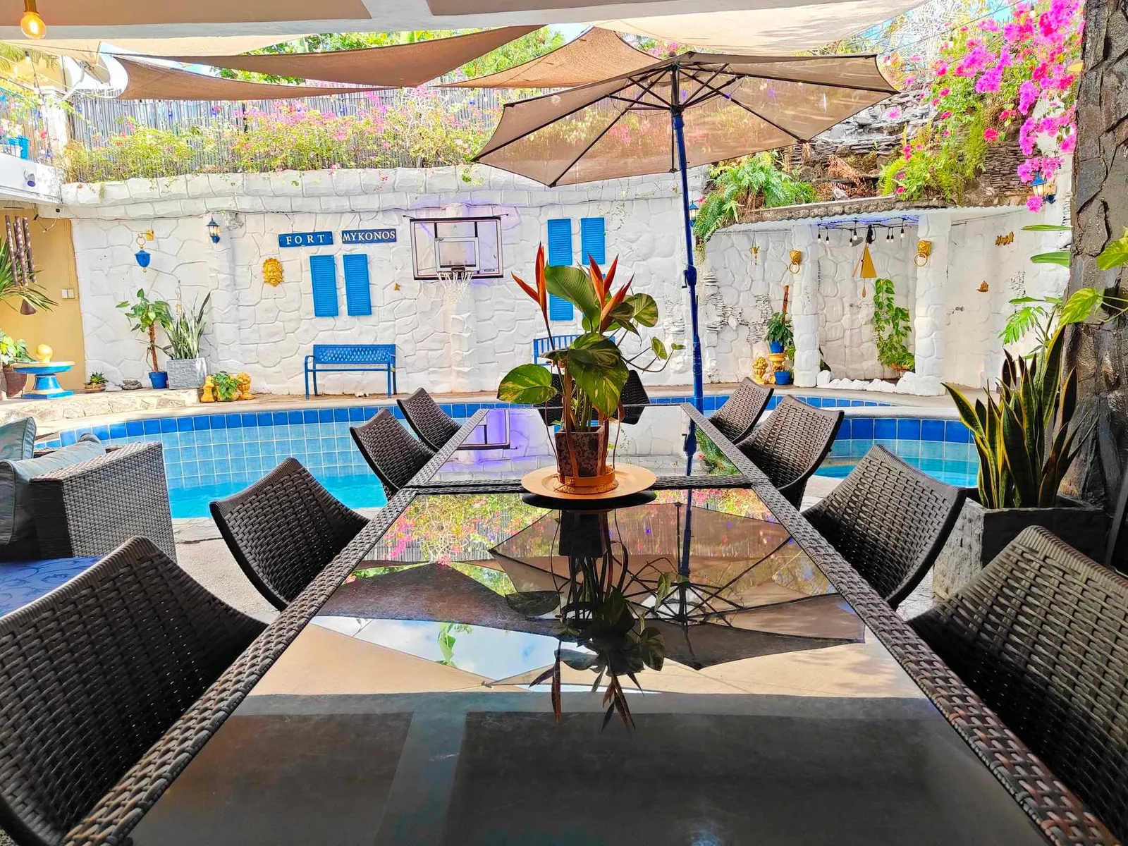 Glass dining table by the pool