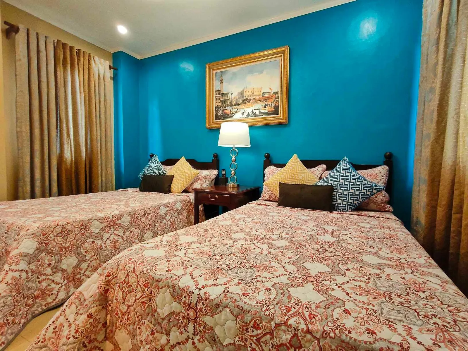 Teal room with patterned bedcovers